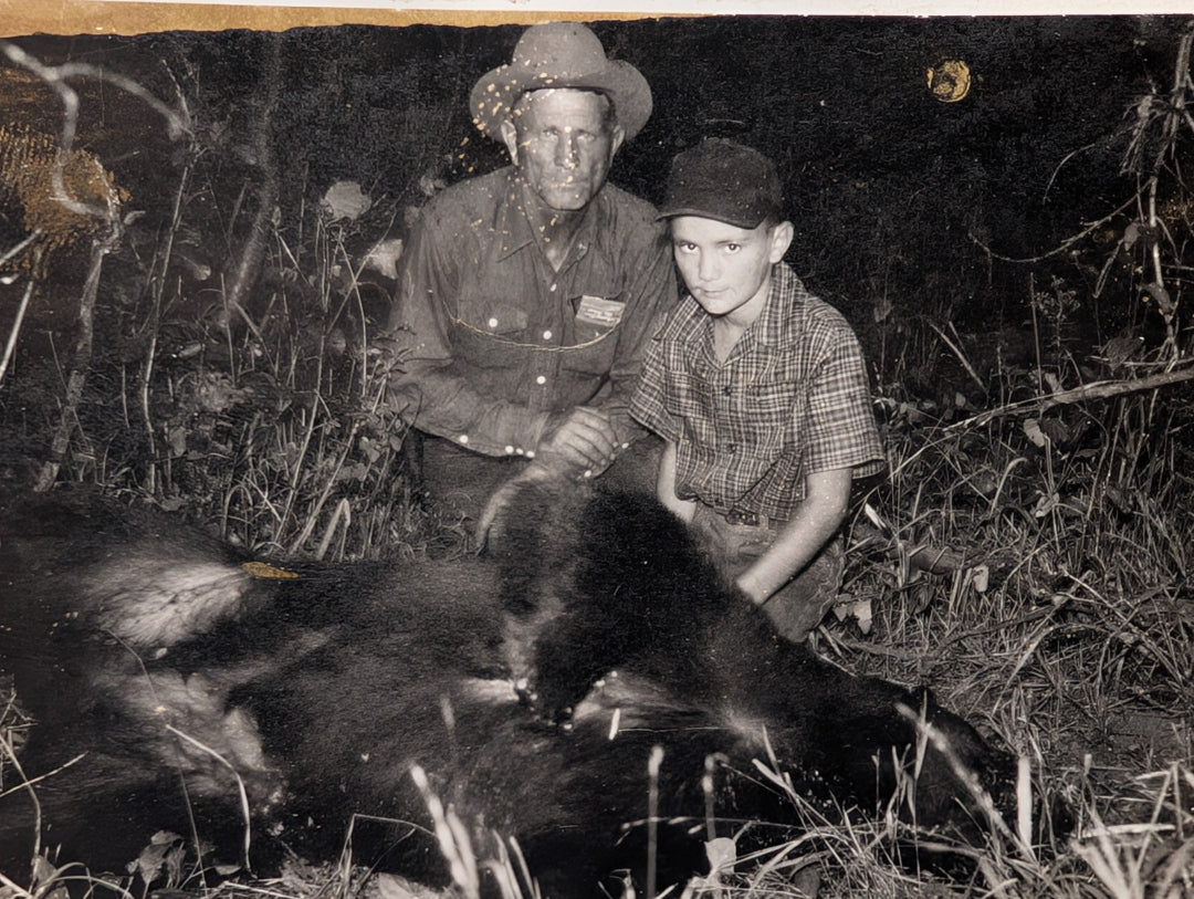 “Young boy facing a black bear near ranchland, illustrating the fragile boundary between wildlife and livestock.”
