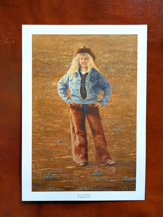 Contemporary western art print by Ted Sorensen featuring a cowgirl in denim jacket and brown chaps