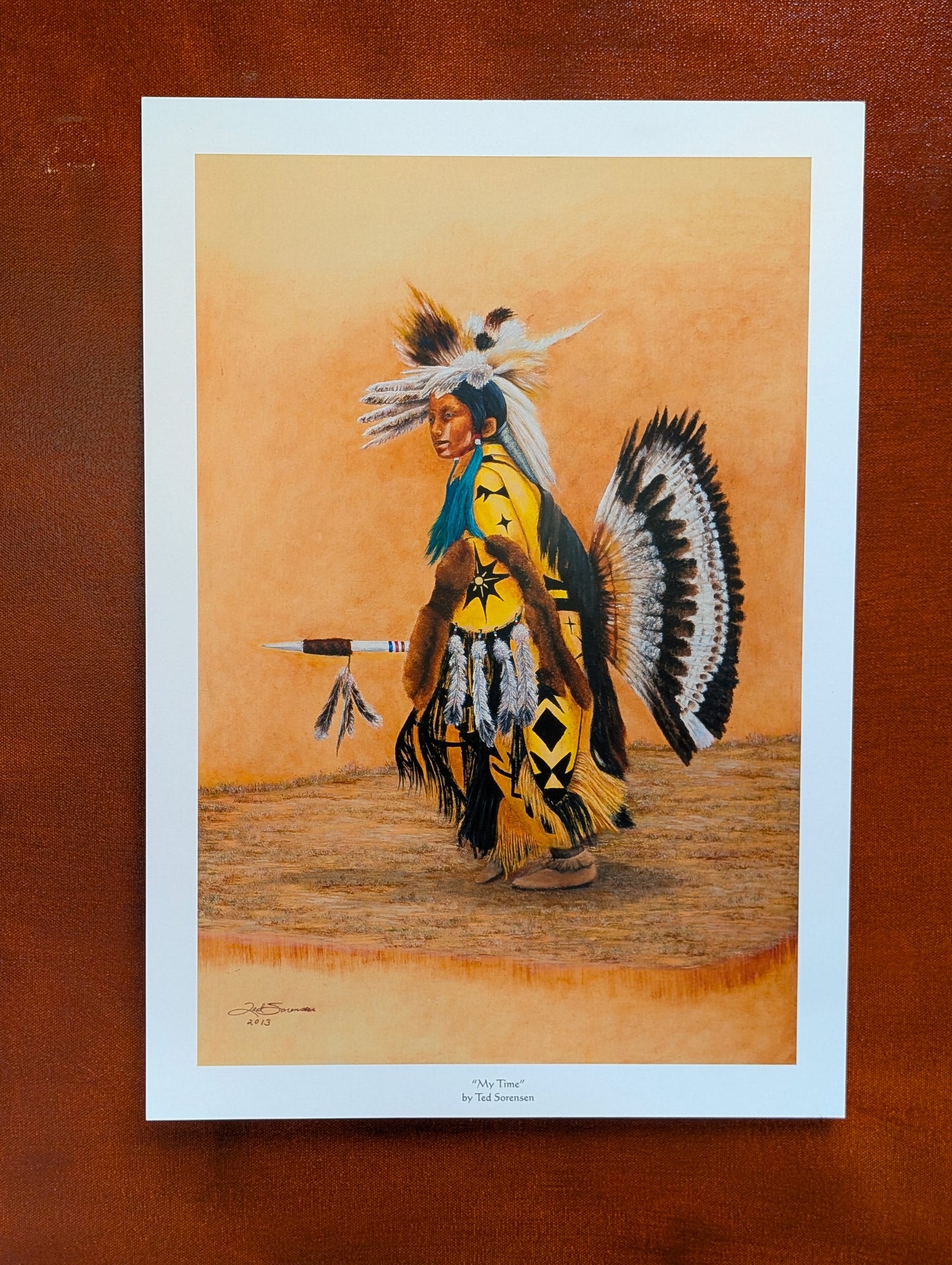 Native American open edition art print by Ted Sorensen featuring a traditional dancer in yellow regalia with feathers and spear