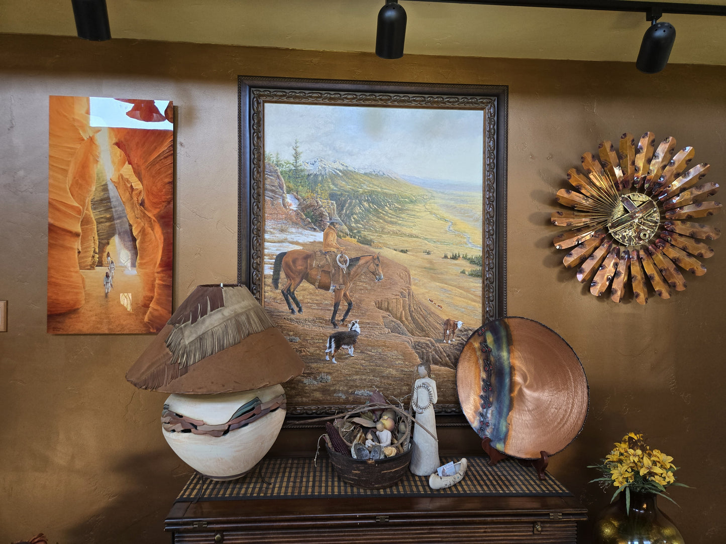 Original western oil painting by Ted Sorensen displayed on wall above rustic decor and Native American art pieces