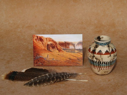 Southwestern mini panel art by Ted Sorensen depicting desert landscape with arch, next to Native American pottery and feathers