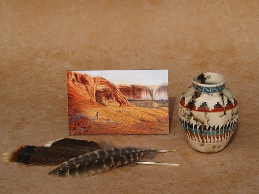 Southwestern mini panel art by Ted Sorensen depicting desert landscape with arch, next to Native American pottery and feathers