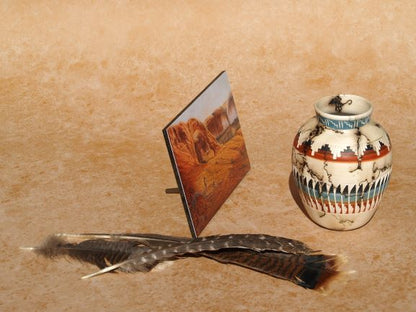 Southwestern mini panel art by Ted Sorensen displayed with Native American style vase and feathers on textured background
