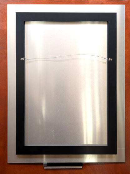 Back view of a Western art metal print by Ted Sorensen featuring hanging wire and black frame
