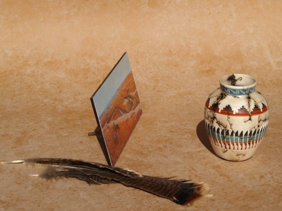 Western mini art panel by Ted Sorensen displayed with decorative Native American pottery and feathers